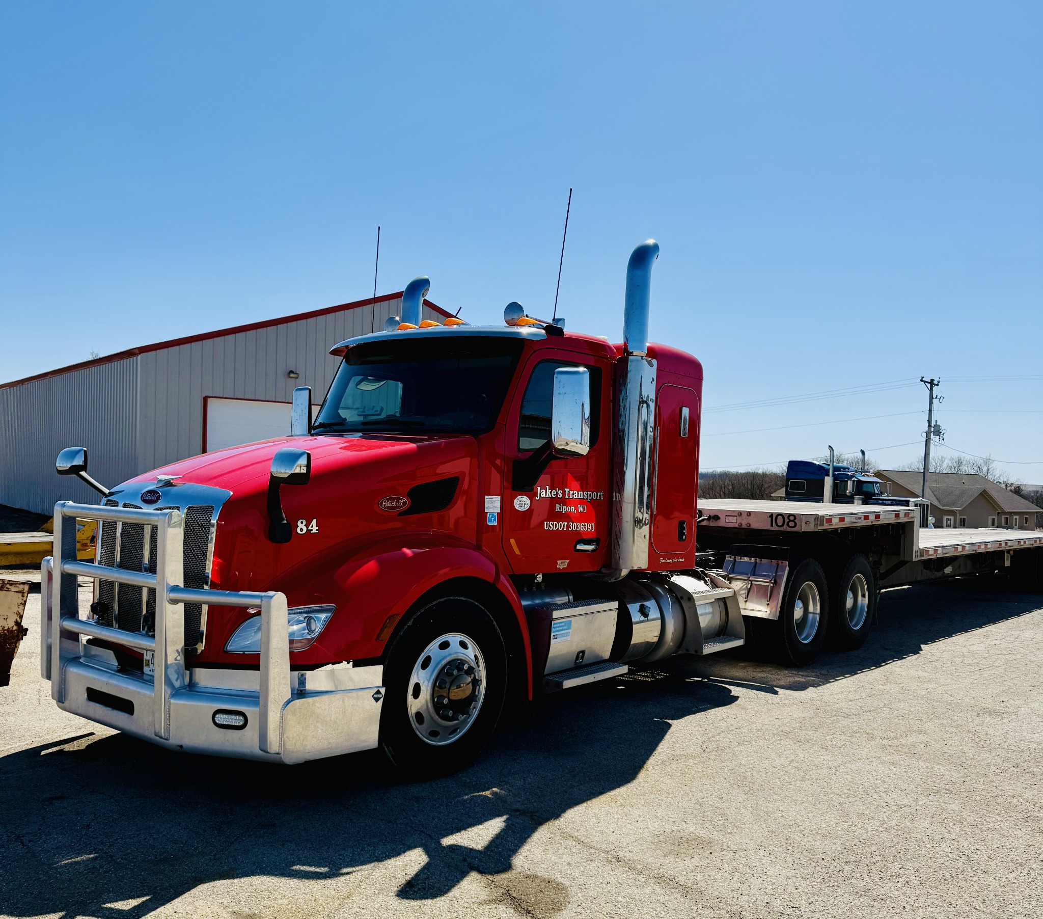 Red semi truck outside the Black Gold Diesel Services shop
